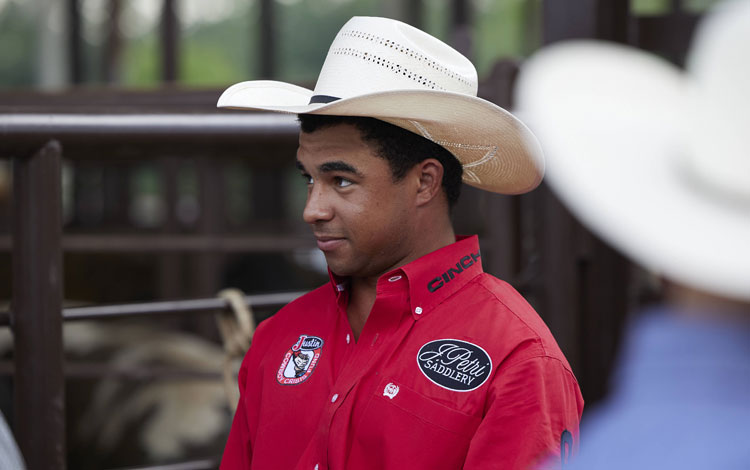 Laramie Mosley wearing a cowboy hat looking away from the camera.